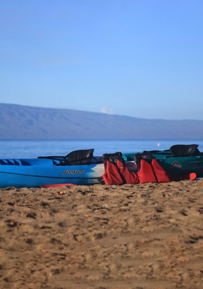 kayaks with life jackets on the beach