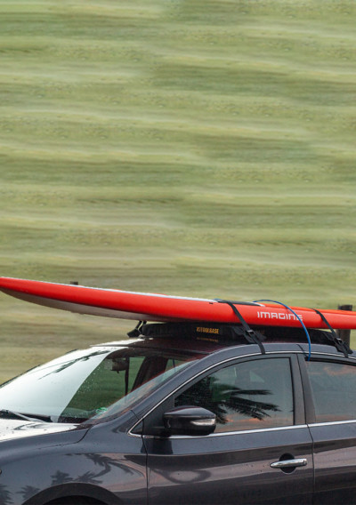 car with roof rack and paddle board